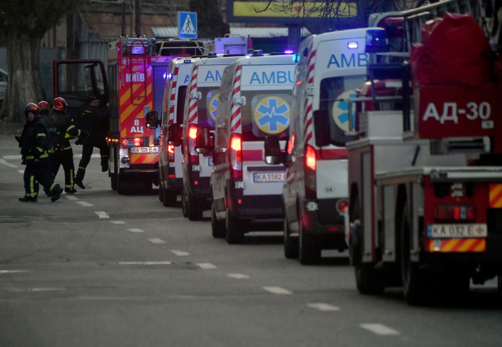 Rescuers leave their vehicles as they arrive at the site of an explosion after Russian drone attacks in Kyiv on November 25, 2023, amid the Russian invasion of Ukraine. — AFP pic