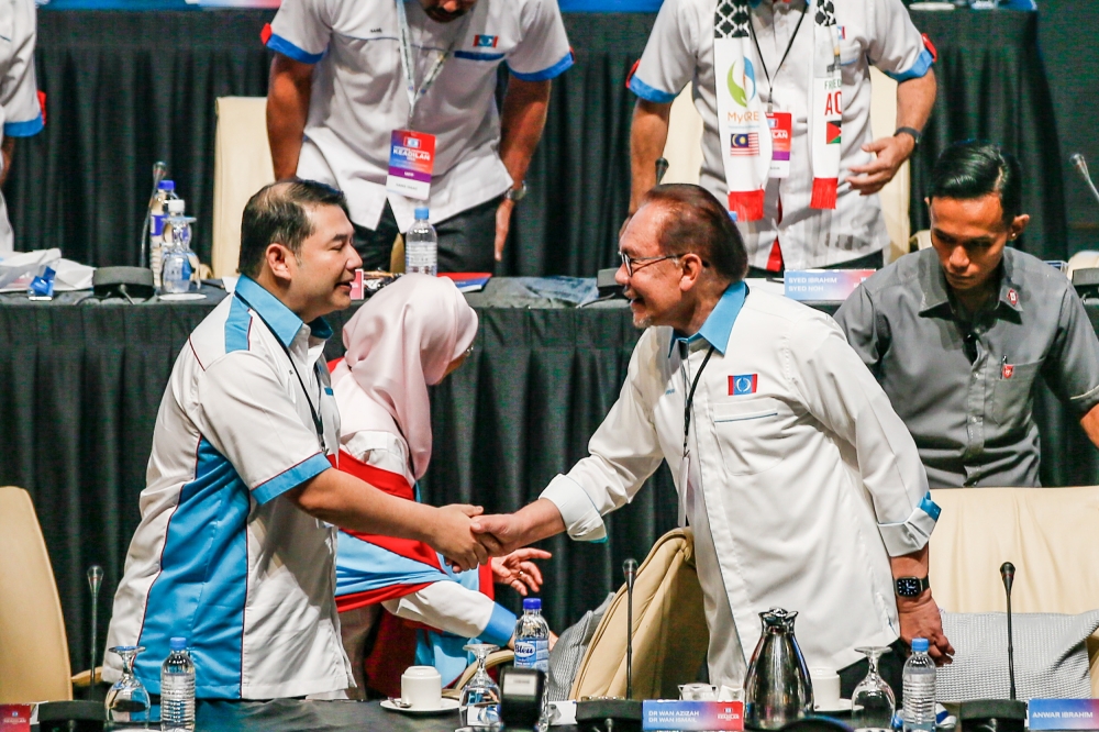 Prime Minister Datuk Seri Anwar Ibrahim (right) greeting PKR deputy president Rafizi Ramli (left) during the PKR Annual National Congress at the Putrajaya International Convention Centre (PICC) November 26, 2023. — Picture by Hari Anggara.