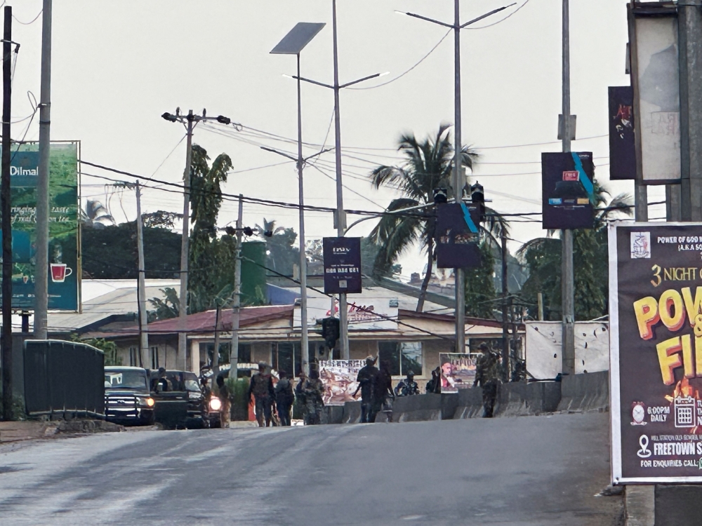 Hooded armed men in military fatigues stand on a street after unidentified gunmen attacked military barracks and attempted to break into an armoury at Congo Cross roundabout in Freetown, Sierra Leone November 26, 2023. — Reuters pic