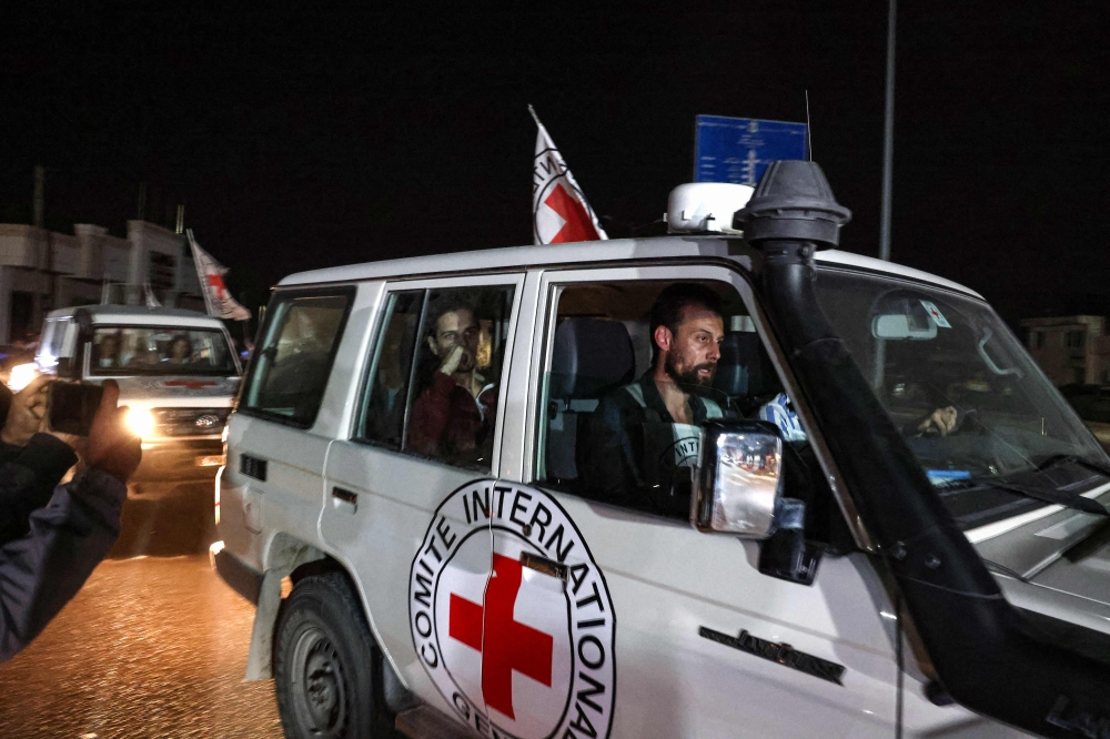 An International Red Cross vehicle carrying Israeli Russian hostage Ron Krivoy released by Hamas drives towards the Rafah border point with Egypt. — AFP pic