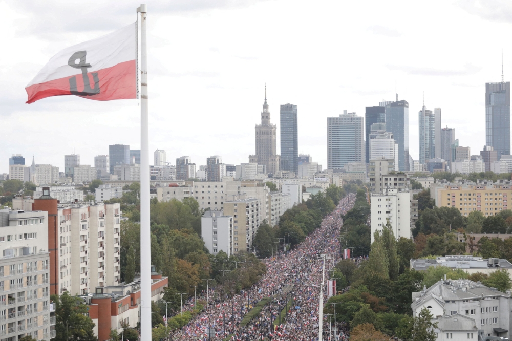 A giant Second World War Polish Home Army flag is seen, as participants attend the 