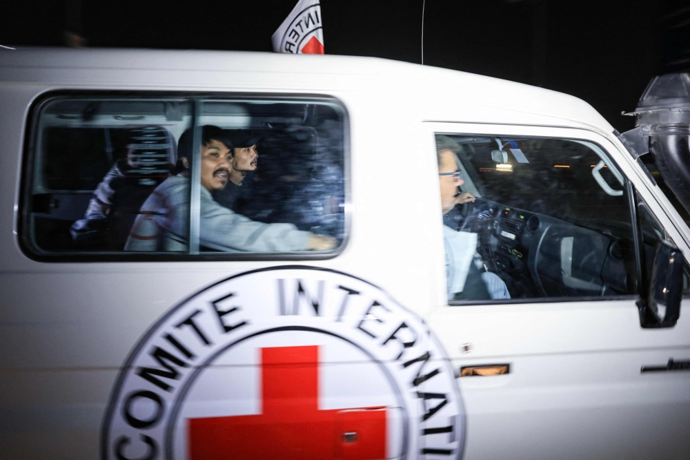 An International Red Cross vehicle carrying Thai hostages released by Hamas drives towards the Rafah border point with Egypt ahead of their transfer to Israel on November 26, 2023. — AFP pic 
