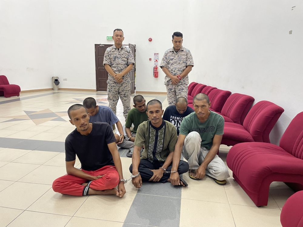 Some of the Indonesian skippers and crew members seen at the Kuching Court’s waiting area. ― Borneo Post pic