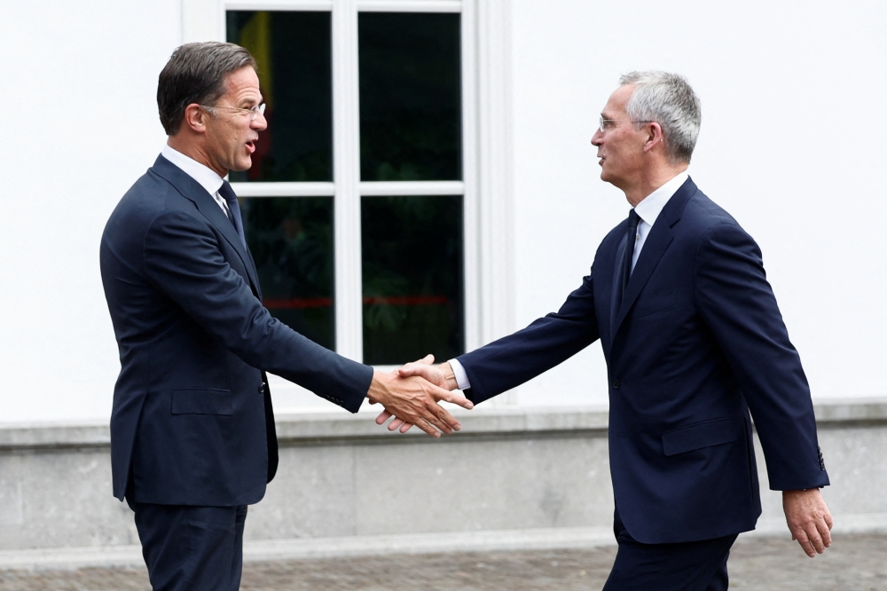 Dutch Prime Minister Mark Rutte shakes hands with Nato Secretary General Jens Stoltenberg as they arrive to meet ahead of a working dinner for Nato leaders at the Catshuis, in The Hague, Netherlands June 27, 2023. — Reuters pic