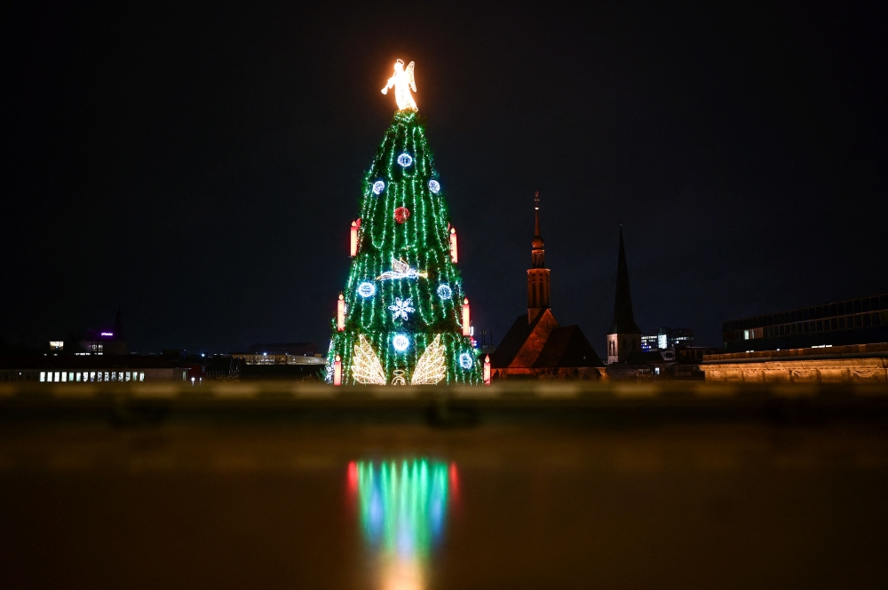 A photo taken on November 27, 2023 shows a Christmas tree made of more than 1000 individual red spruces from the Sauerland region, after it was officially inaugurated with its illumination, at the Christmas market in Dortmund, western Germany. — AFP pic