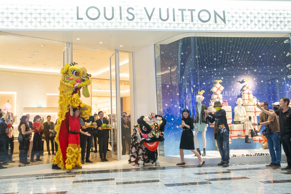 A lion dance performance in front of French luxury brand Louis Vuitton, located at the main entrance. — Picture by Raymond Manuel