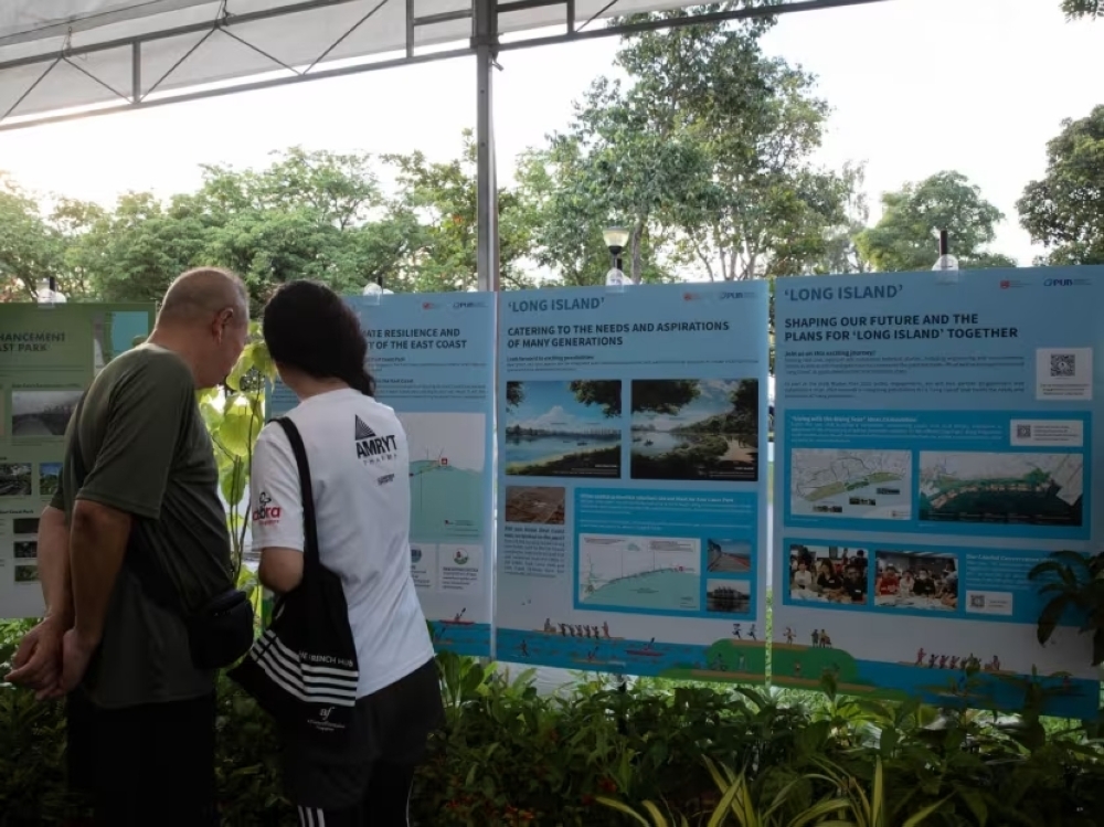 People at East Coast park looking at the plans for Long Island, a major reclamation project being planned for the future in the area. — TODAY pic