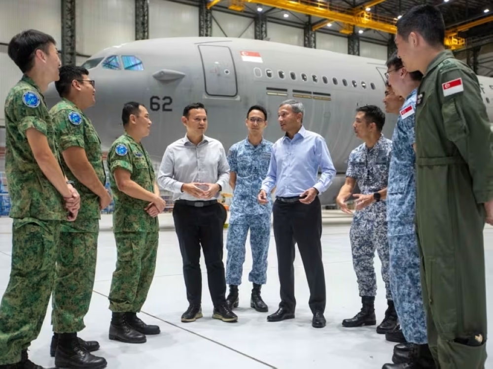 Dr Vivian Balakrishnan (sixth from left) speaking with Singapore Armed Forces personnel at Changi Air Base (East). — TODAY pic