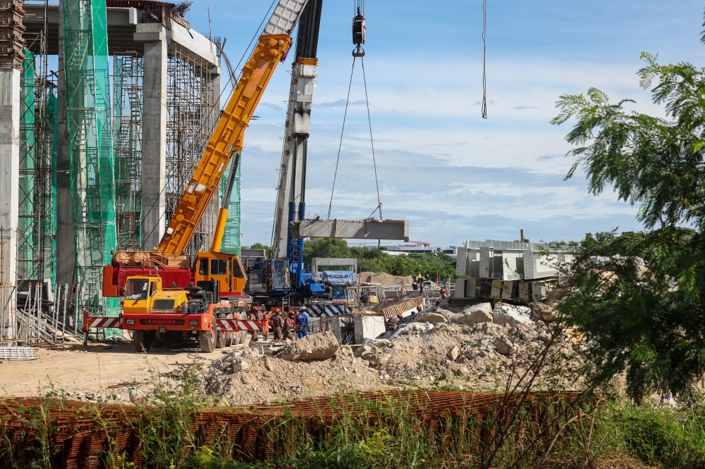 File picture of rescue personnel working to rescue the victims buried under the rubble after the warehouse collapse. The construction company in the logistics warehouse construction project incident in Batu Maung which collapsed on Tuesday night was ordered to appoint an independent investigator to identify the cause of the incident and assess the quality of the construction structure at the site. ― Bernama pic