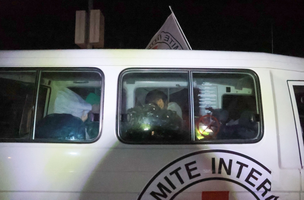 A Red Cross convoy transporting released Israeli hostages arrives at Rafah crossing point in the southern Gaza Strip on November 30, 2023, amid the release of Palestinian prisoners in exchange for Israeli hostages held by Hamas in Gaza since October 7. — AFP pic