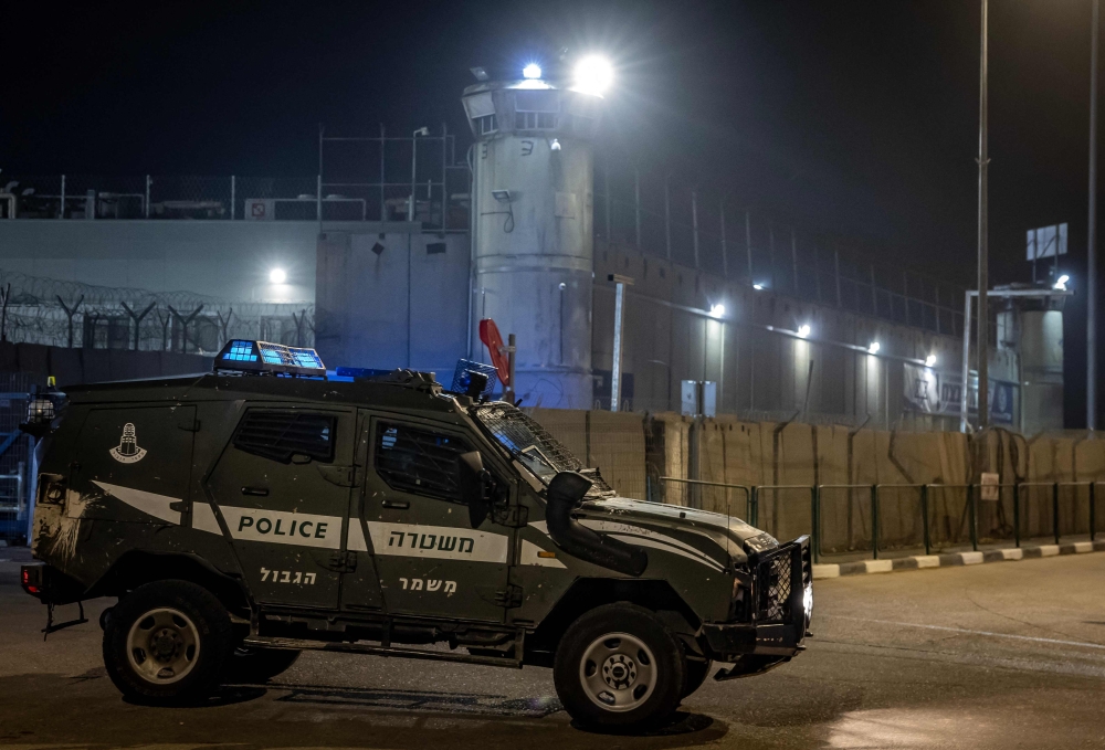An Israeli border guard vehicle leaves the Ofer military prison located between Ramallah and Beitunia in the occupied West Bank on November 30, 2023, amid preparations for the release of Palestinian prisoners in exchange for Israeli hostages held by Hamas in Gaza since the October 7 attacks. — AFP pic