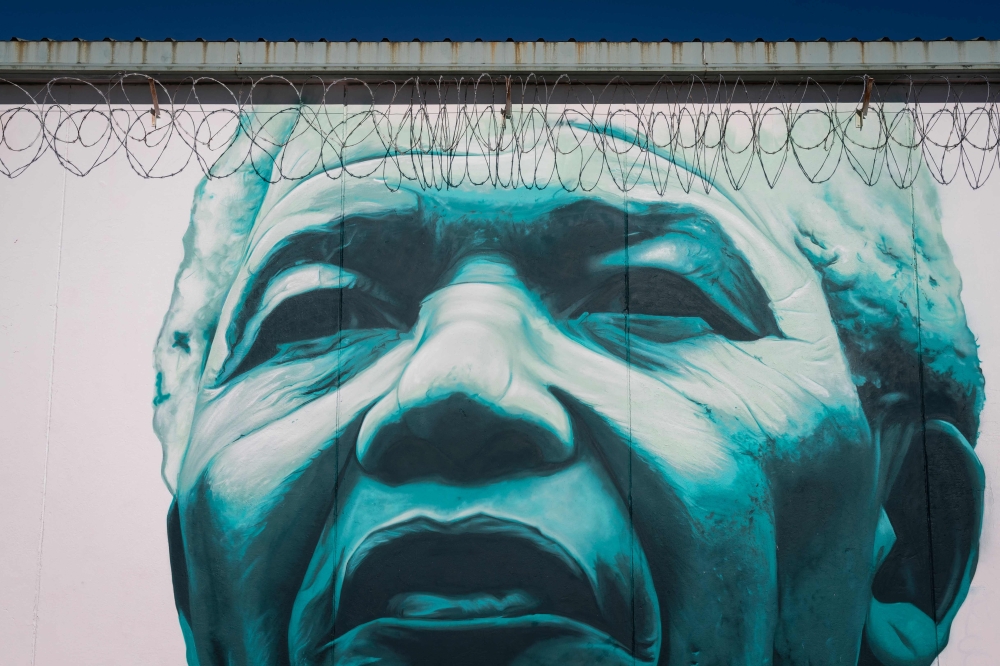A mural depicting former South Africa President Nelson Mandela covers a wall of the yard of the Teixeiro prison, near A Coruna, on October 5, 2023. — AFP pic