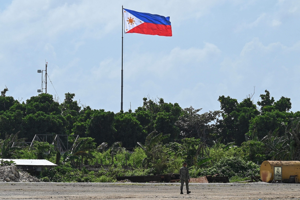 A Philippine soldier walks on Thitu Island in the disputed South China Sea December 1, 2023. — AFP pic