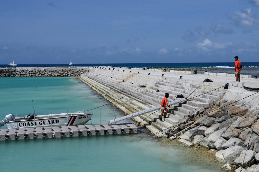 Philippine Coast Guard personnel are seen on Thitu Island in the disputed South China Sea December 1, 2023. — AFP pic