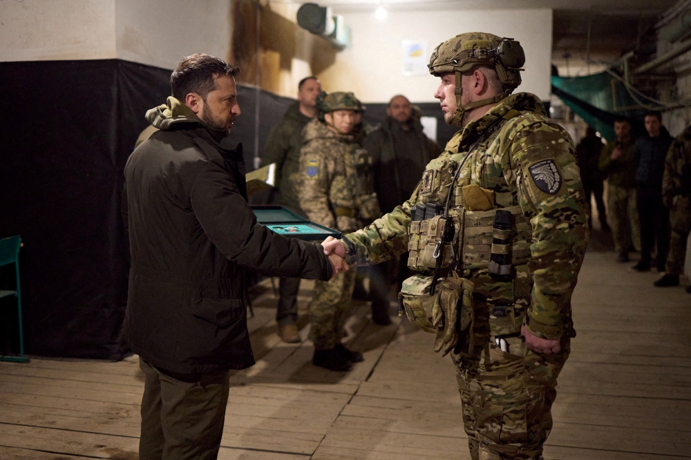 FILE PHOTO: Ukraine's President Volodymyr Zelenskiy awards a Ukrainian serviceman at a position in the town of Kupiansk, amid Russia's attack on Ukraine, in Kharkiv region, Ukraine November 30, 2023. — Picture courtesy of Ukrainian Presidential Press Service/Handout via Reuters