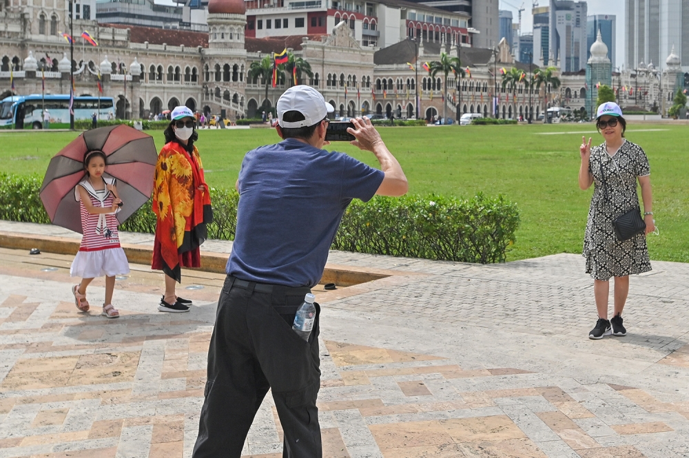 Tourists are seen at Dataran Merdeka in Kuala Lumpur in this file photo taken on February 14, 2023. — Picture by Miera Zulyana