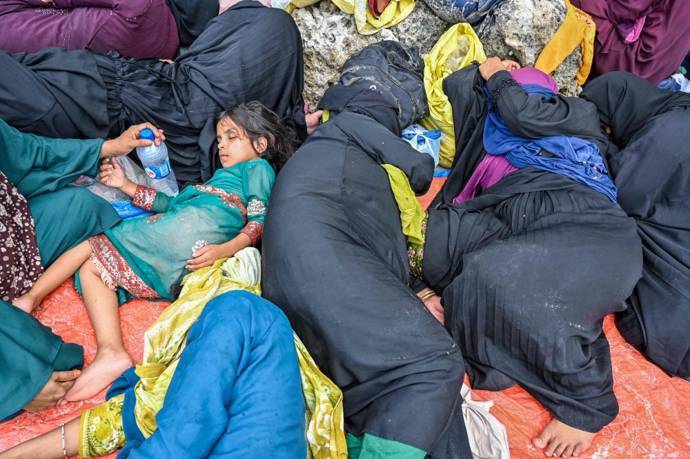 Newly-arrived Rohingya refugees rest at a beach on Sabang island, Aceh province December 2, 2023. — AFP pic