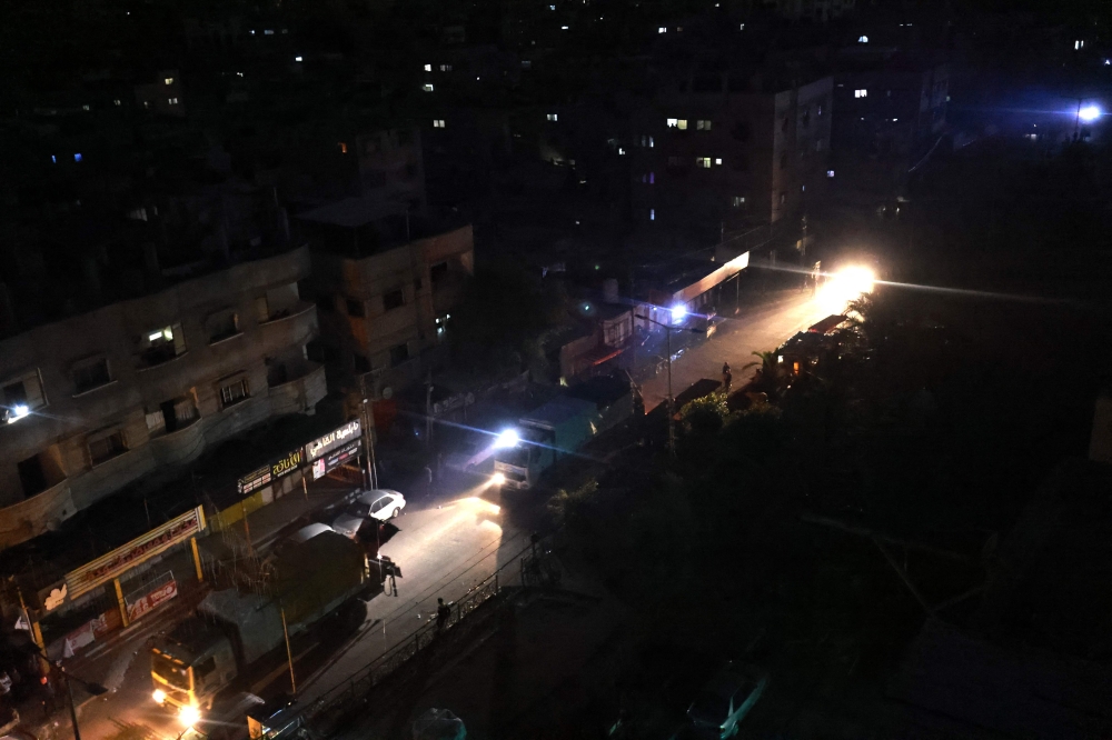 Aid trucks that entered the Gaza Strip via the Rafah crossing with Egypt before the end of a 7-day ceasefire, drive down a road in Rafah in the southern Palestinian territory December 1, 2023. — AFP pic