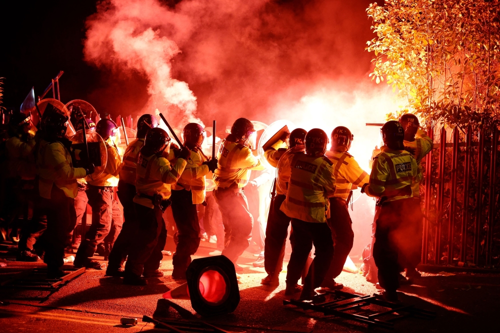 Legia Warsaw fans let off flares as they clash with police officers outside the stadium before the Europa Conference League Group E match between Aston Villa and Legia Warsaw at Villa Park, Birmingham November 30, 2023. — Action Images via Reuters/Paul Childs