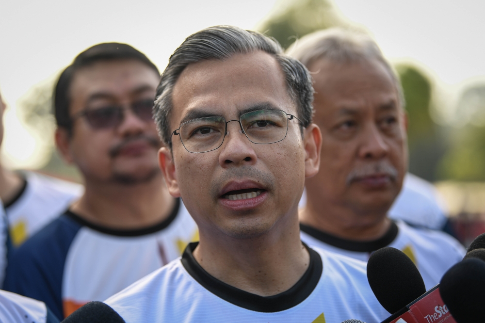 Minister of Communications and Digital Fahmi Fadzil speaks to reporters at the Runhack: Scam Alert 2023 programme at the Bukit Jalil National Stadium. — Bernama pic