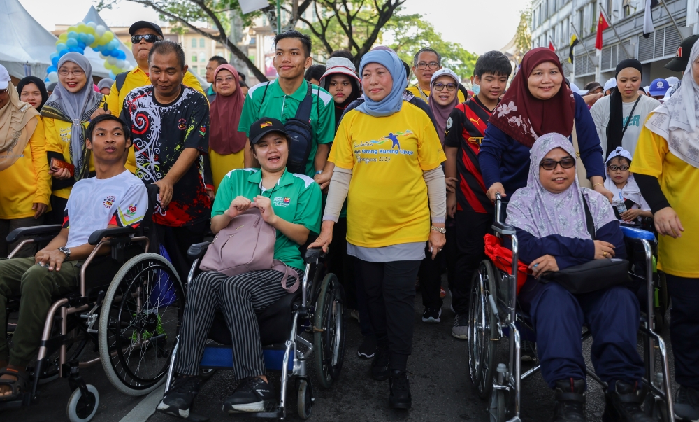 Women, Family, and Community Development Minister (KPWKM) Datuk Seri Nancy Shukri takes part in the Fun Walk in conjunction with National PwD Day celebrations at Dataran Merdeka. — Bernama pic