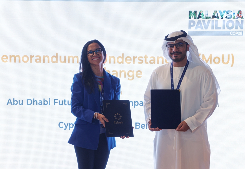 Cypark Resources Berhad Chairman Datuk Hamidah Moris and Masdar Chief Executive Officer Mohamed Jameel Al Ramahi exchanging document on Memorandum of Understanding  between Abu Dhabi Future Energy Company PJSC-Masdar and Cypark Resources Berhad for potential collaboration during the official launch of Malaysia Pavilion at the 28th Conference of Parties (COP28) to the United Nations Framework Convention on Climate Change (UNFCC), in Dubai Expo City December 1, 2023. — Bernama pic