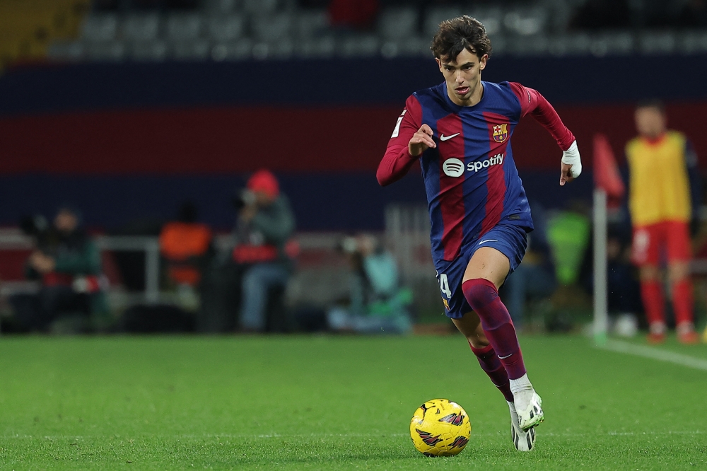 Barcelona's Portuguese forward #14 Joao Felix dribbles the ball during the Spanish league football match between FC Barcelona and Club Atletico de Madrid at the Estadi Olimpic Lluis Companys in Barcelona on December 3, 2023. — AFP pic