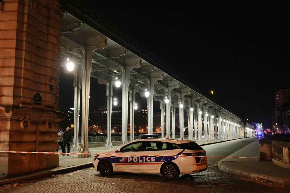 A police car is parked in a security perimetre set after one person was killed and two others wounded in a knife attack in Paris, on December 2, 2023. — AFP pic