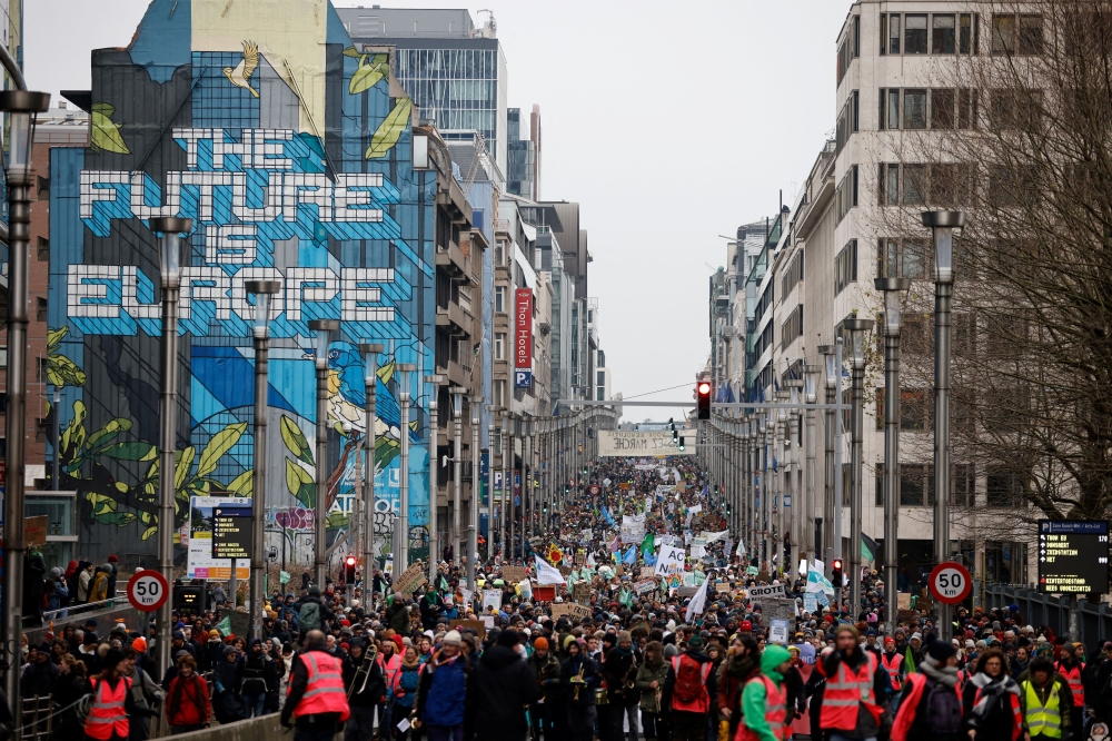 People take part in a climate protest coinciding with COP28 being held in Dubai and ahead of the upcoming Belgian presidency of the Council of the European Union, in Brussels, Belgium, December 3, 2023. — Reuters pic