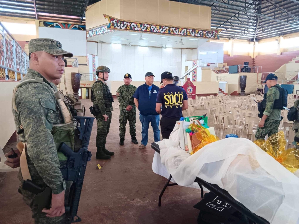 Lanao Del Sur Governor Mamintal Adiong Jr. stands among law enforcement officers as they investigate the scene of an explosion that occurred during a Catholic Mass in a gymnasium at Mindanao State University in Marawi, Philippines, December 3, 2023. — Lanao Del Sur Provincial Government/Handout via Reuters pic