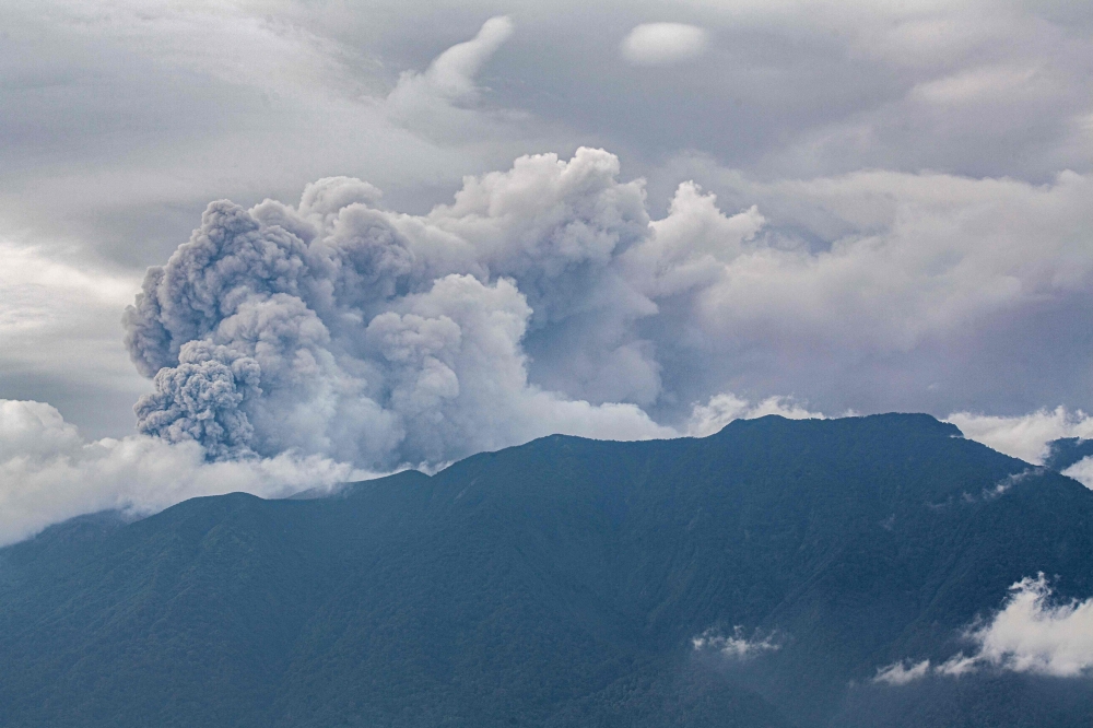 Volcanic ash spews from Mount Marapi during an eruption as seen from Tanah Datar in West Sumatra on December 3, 2023. — AFP pic