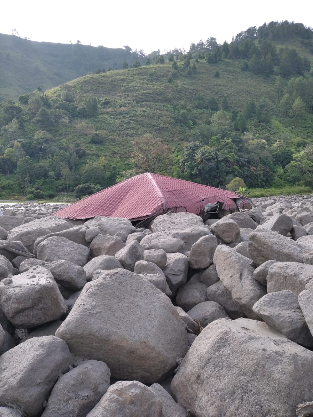 The landslide and floods caused by torrential rain hit residential areas in a village in North Sumatra province late on Friday, killing one person, a 78-year-old woman, sweeping away dozens of houses and destroying a hotel. — Picture via Facebook.com/InfoBencanaBNPB