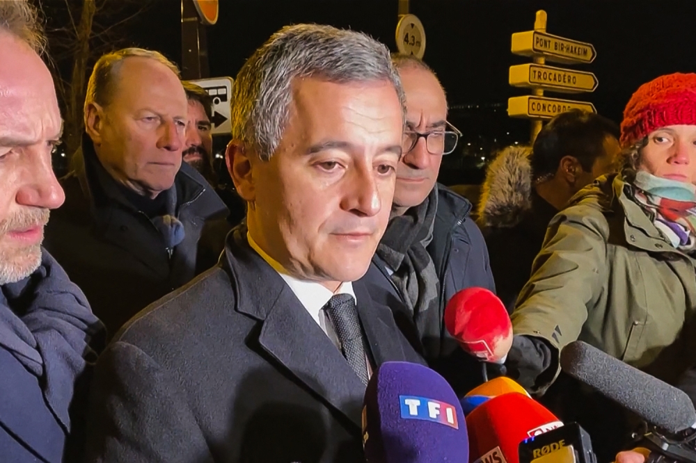 This image grab taken from an AFP TV video shows French Interior Minister Gerald Darmanin (centre) speaking to the press next to Paris Police prefect Laurent Nunez (2nd right) after a stabbing in Paris December 3, 2023. — AFP pic