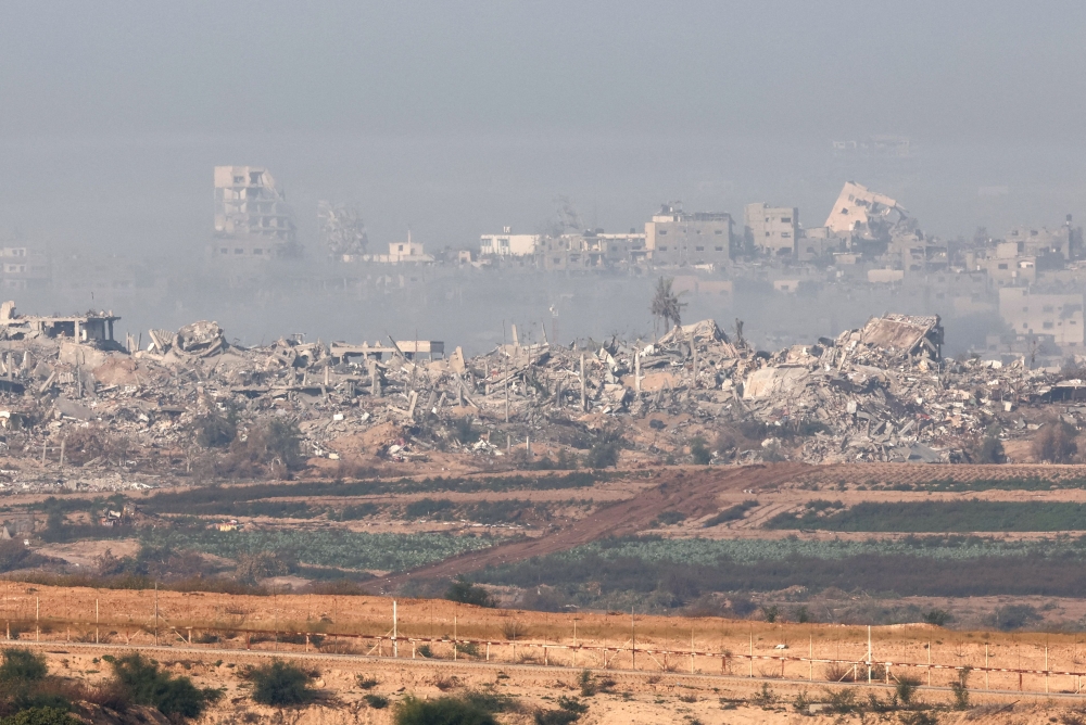 A picture taken from southern Israel near the border with the Gaza Strip on December 4, 2023, shows smoke lingering over the Palestinian territory following Israeli bombardment amid continuing battles between Israel and the militant group Hamas. — AFP pic