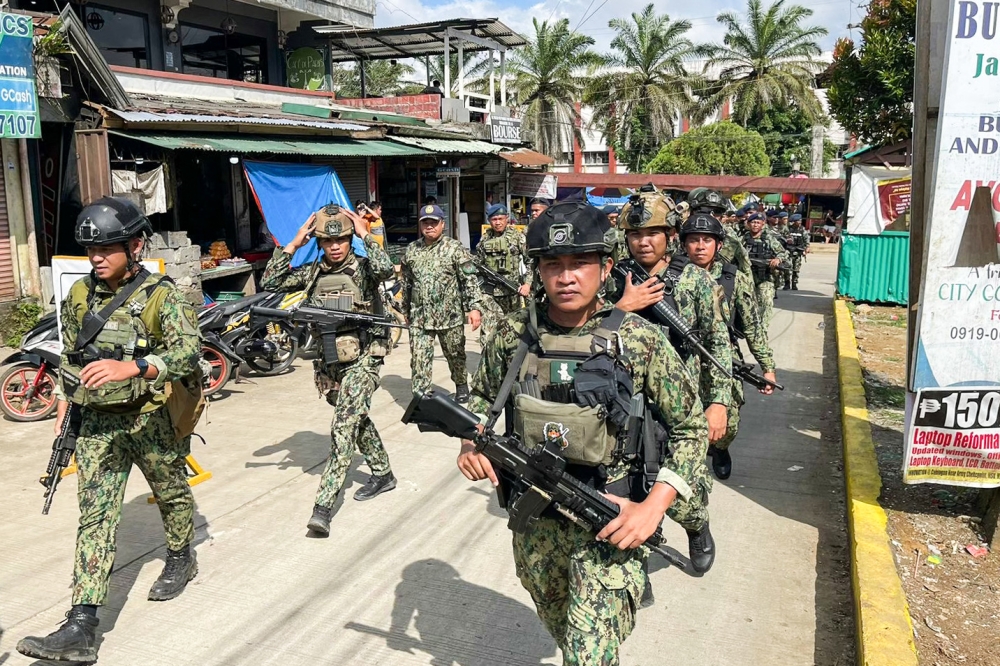 Policemen and soldiers from the military arrive at Mindanao State University in Marawi City, Lanao del Sur province on December 4, 2023, a day after a bomb attack. At least four people died and dozens were wounded on December 3, 2023 in a bomb attack on a Catholic mass in the insurgency-plagued southern Philippines. — AFP pic