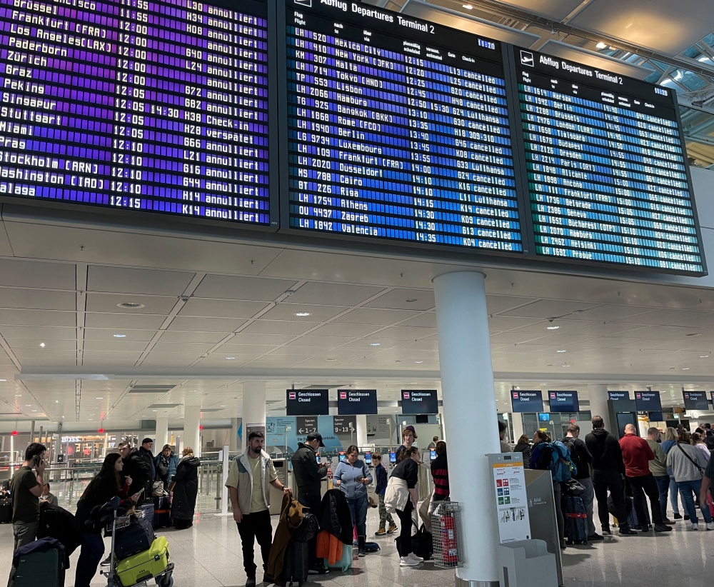 Passengers stand in line at Munich's airport after heavy snowfall hit Bavaria and its capital Munich, Germany, December 2, 2023. — Reuters pic