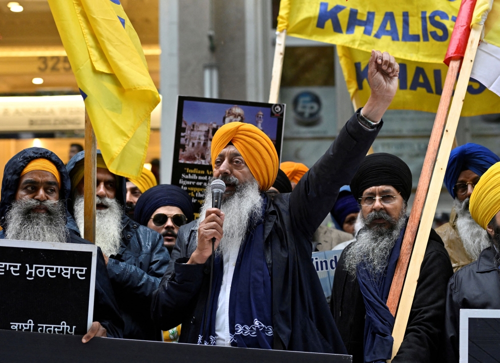 FILE PHOTO: A demonstrator uses a microphone as others hold flags and signs as they protest outside India's consulate, a week after Canada's Prime Minister Justin Trudeau raised the prospect of New Delhi's involvement in the murder of Sikh separatist leader Hardeep Singh Nijjar, in Vancouver, British Columbia, Canada September 25, 2023. — Reuters file pic