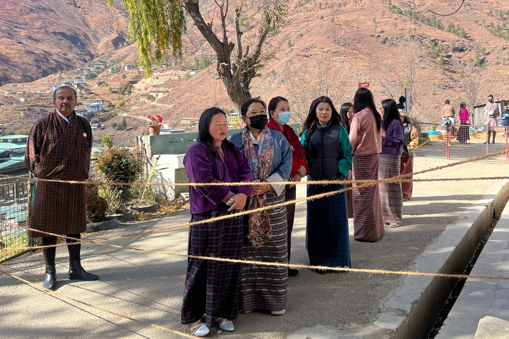 Bhutanese citizens queue to vote at a polling station in the capital Thimpu on November 30, 2023, in primary polls to choose the top two political parties who will contest the general election in the tiny Himalayan kingdom's history in January 2024. — AFP pic