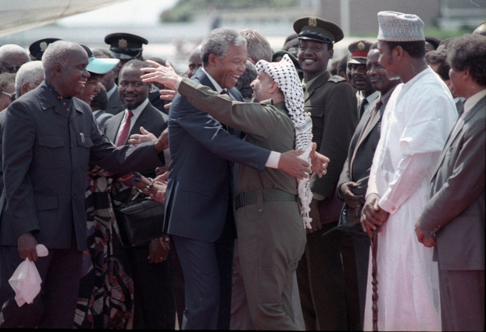 Nelson Mandela is embraced by PLO leader Yasser Arafat as he arrives at Lusaka airport February 27, 1990. — Reuters file pic