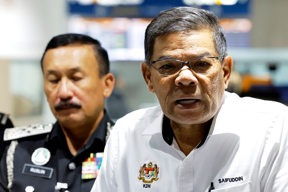 Home Minister Datuk Seri Saifuddin Nasution Ismail (right) said the reason for the exemption was that there were Singaporeans who enter Malaysia on an almost daily basis, and therefore, it is more realistic to exempt them from filling in the MDAC. — Bernama pic