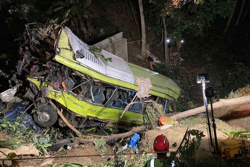 Rescue personnel working at the scene where a bus plunged into a ravine in Hamtic town, Antique province, central Philippines. ― Handout via AFP