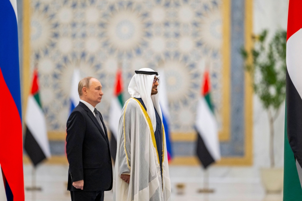 A handout picture provided by the UAE Presidential Court shows President of the United Arab Emirates Sheikh Mohammed bin Zayed Al-Nahyan (right) and Russian President Vladimir Putin stand during a welcome ceremony at Qasr Al-Watan palace in Abu Dhabi December 6, 2023. — UAE Presidential Court/AFP pic 