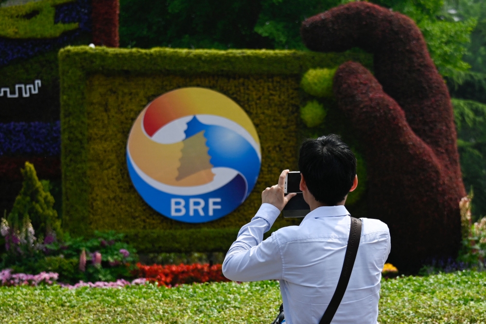 A man takes photo of a sign promoting the Belt and Road Forum in Beijing on April 22, 2019. Italy has formally withdrawn from China's Belt and Road investment plan, four years after becoming the only G7 nation to sign up, a government source said on December 6, 2023. — AFP pic