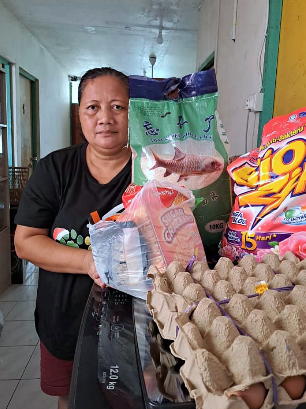 Kebang shows the items she bought using the eMadani credit. ― Borneo Post pic