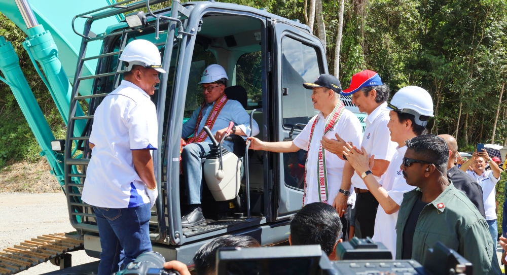 Prime Minister Datuk Seri Anwar Ibrahim (seated in excavator) and Sabah Chief Minister Datuk Seri Hajiji Haji Noor are seen during the groundbreaking ceremony today. — Picture courtesy of Chief Minister’s Department 