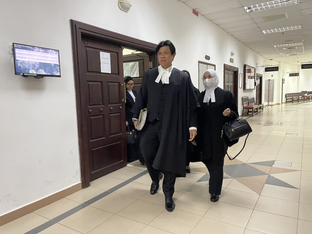 Lawyers Alvin Yong and Azlina Dahlan were seen exiting the High Court here yesterday. ― Borneo Post pic