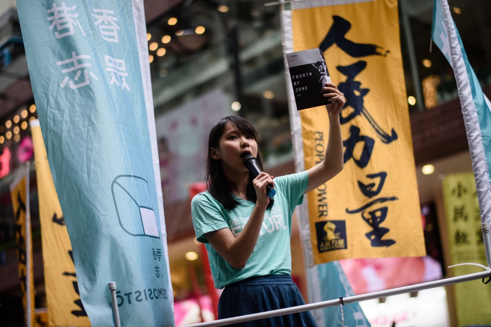 Pro-democracy Demosisto party member Agnes Chow speaks to passing pedestrians in Hong Kong on June 4, 2017, ahead of a candlelight vigil to mark the 28th anniversary of the June 4 Tiananmen crackdown in Beijing in 1989. — AFP pic
