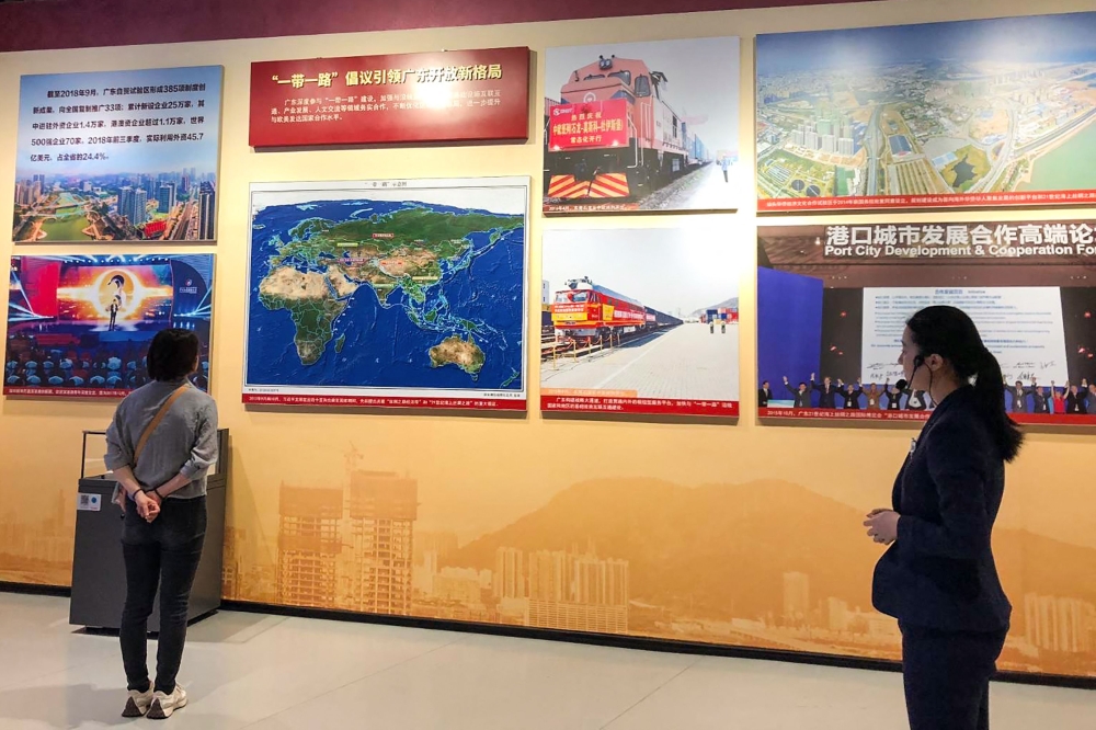 This handout from Hong Kong democracy activist Agnes Chow taken in mid-August 2023 when she travelled with security officers to the mainland Chinese city of Shenzhen and released on December 6, 2023 shows people looking at displays in an exhibition hall in Shenzhen. — Agnes Chow handout pic via AFP 