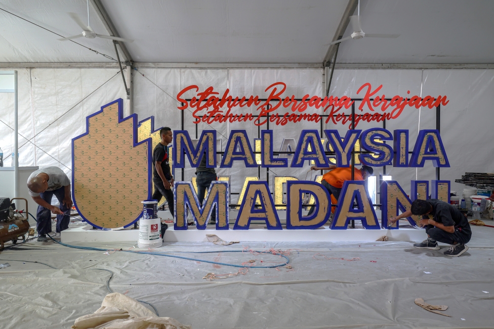 Workers paint a Malaysia Madani sign at the National Stadium Bukit Jalil, December 7, 2023. — Bernama pic 