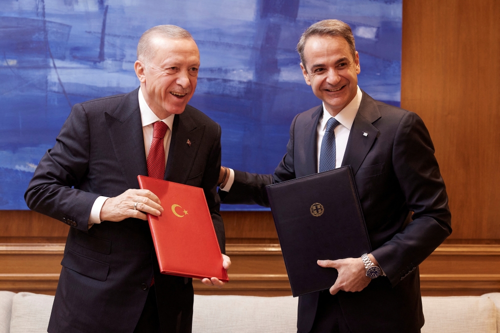 Greek Prime Minister Kyriakos Mitsotakis and Turkish President Tayyip Erdogan smile after signing a joint declaration to pursue good neighbourly relations at the Maximos Mansion in Athens, Greece, December 7, 2023. — Dimitris Papamitsos/Greek Prime Minister’s Office handout pic via Reuters